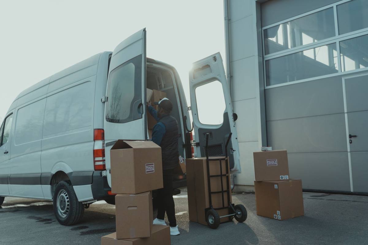A courier loading a van in the morning