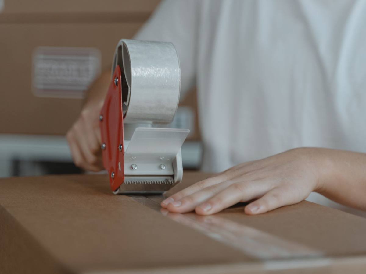 Packing tape being applied to a moving box