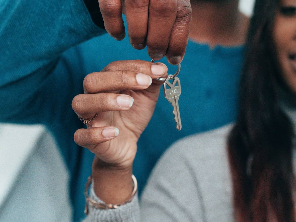 A family holding house keys on moving day