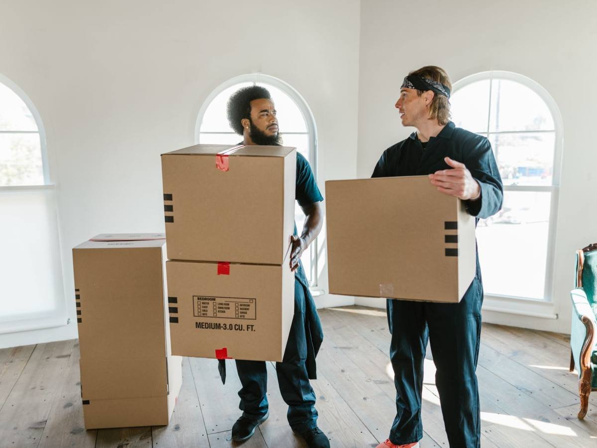 Movers wrapping furniture for transit